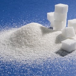 Sugar cubes against a blue background